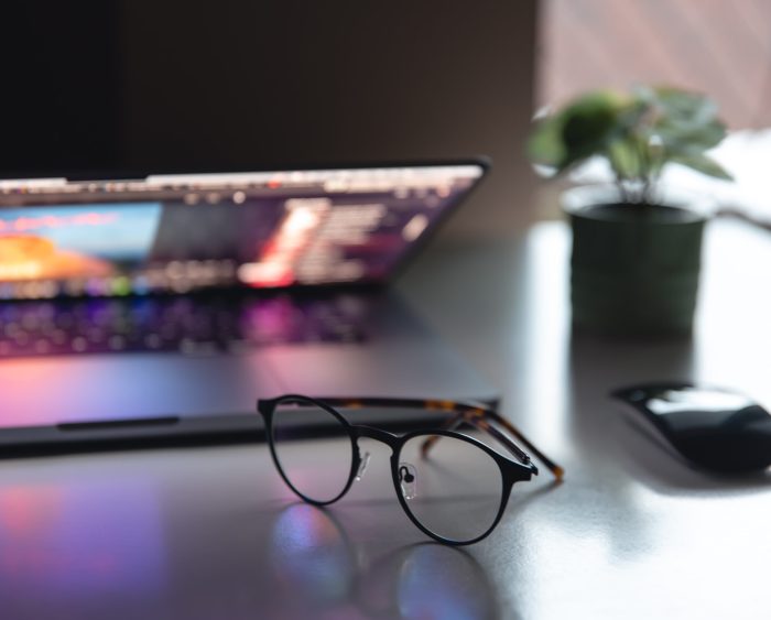 Colorful close up of a laptop keyboard working home or office at night with the illumination of a screen display with multiple colors background..